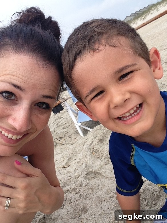 Little beach boy playing in the sand