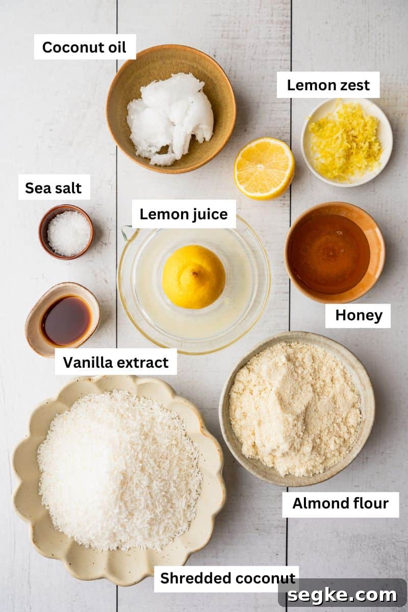 Bowls with different foods in them including coconut oil, almond flour, lemon zest, honey, shredded coconut and lemon juice.