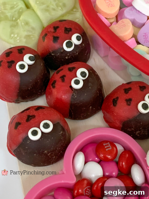 Valentine Charcuterie, best charcuterie ideas, Valentine treat ideas, cute charcuterie boards, heart charcuterie, heart treats, best kids valentine's day ideas, best valentine recipes, easy valentine recipes, easy charcuterie ideas, trader joe's chocolate covered marshmallow love bugs