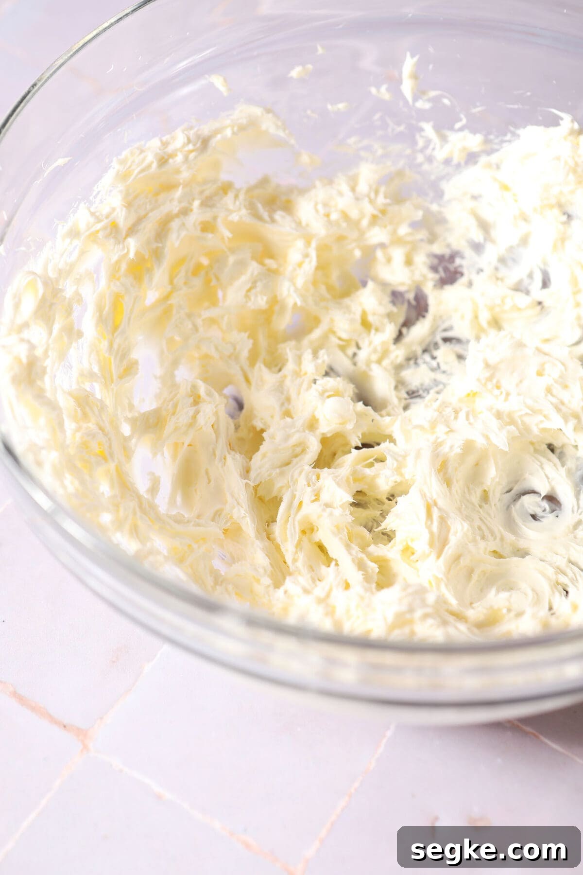 creamed butter and cream cheese in a bowl on a purple surface