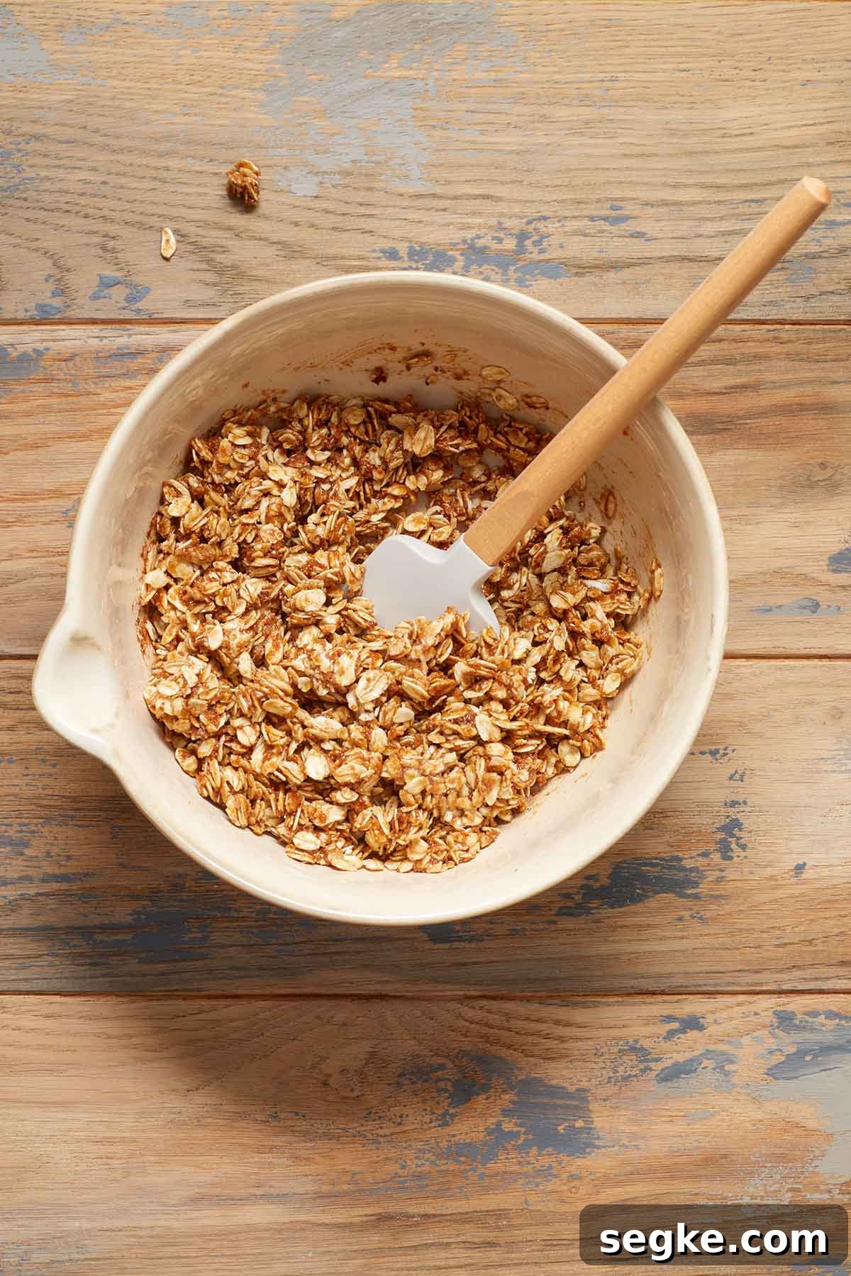 Oat filling mixed together in a bowl with a spatula.