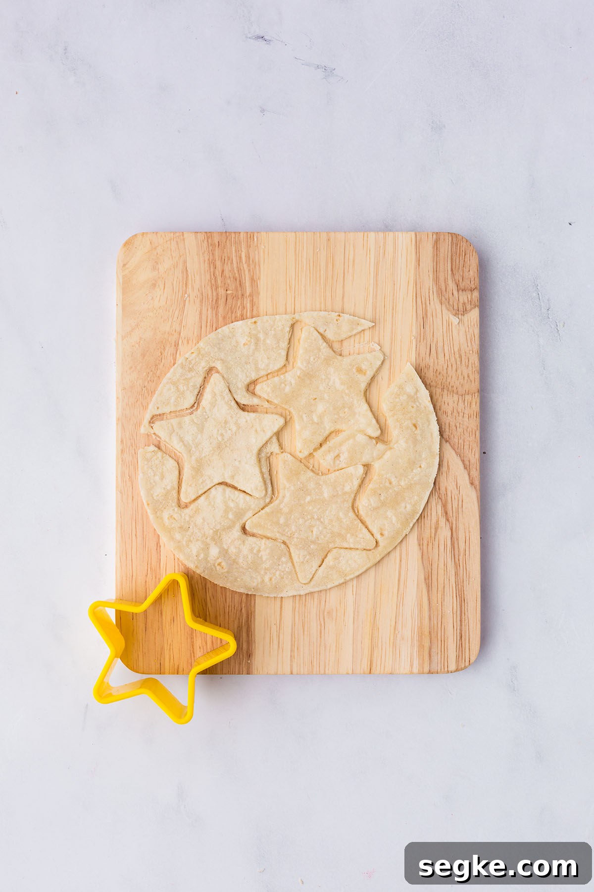 Tortillas are cut with a star cookie cutter.