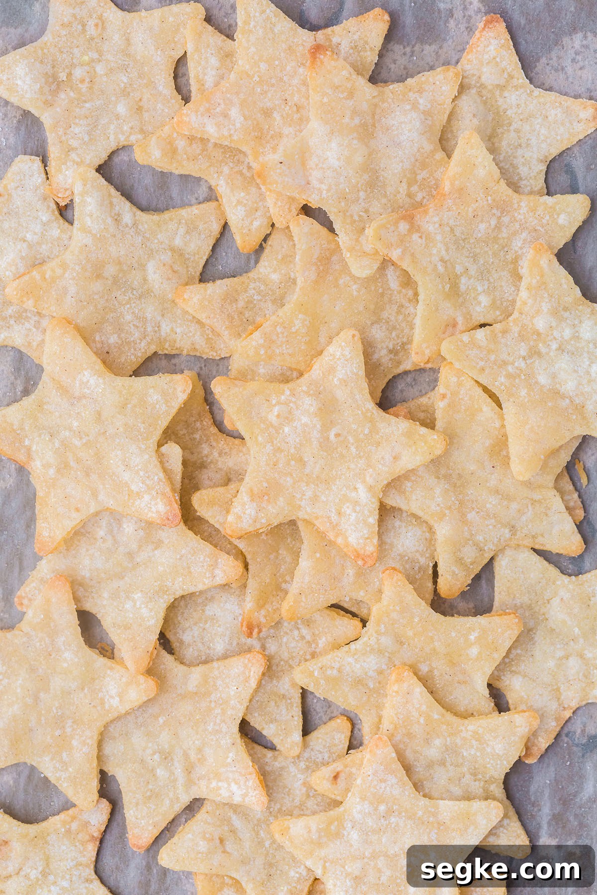 Baked star chips on parchment paper.
