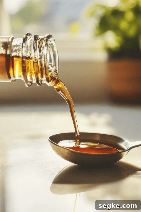 Golden syrup being measure into a spoon