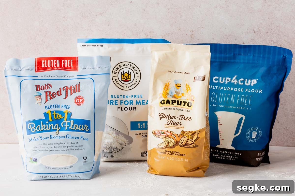 Bob's Red Mill, King Arthur, Caputo Fioreglut, and Cup4Cup gluten-free flours in bags on pink surface.