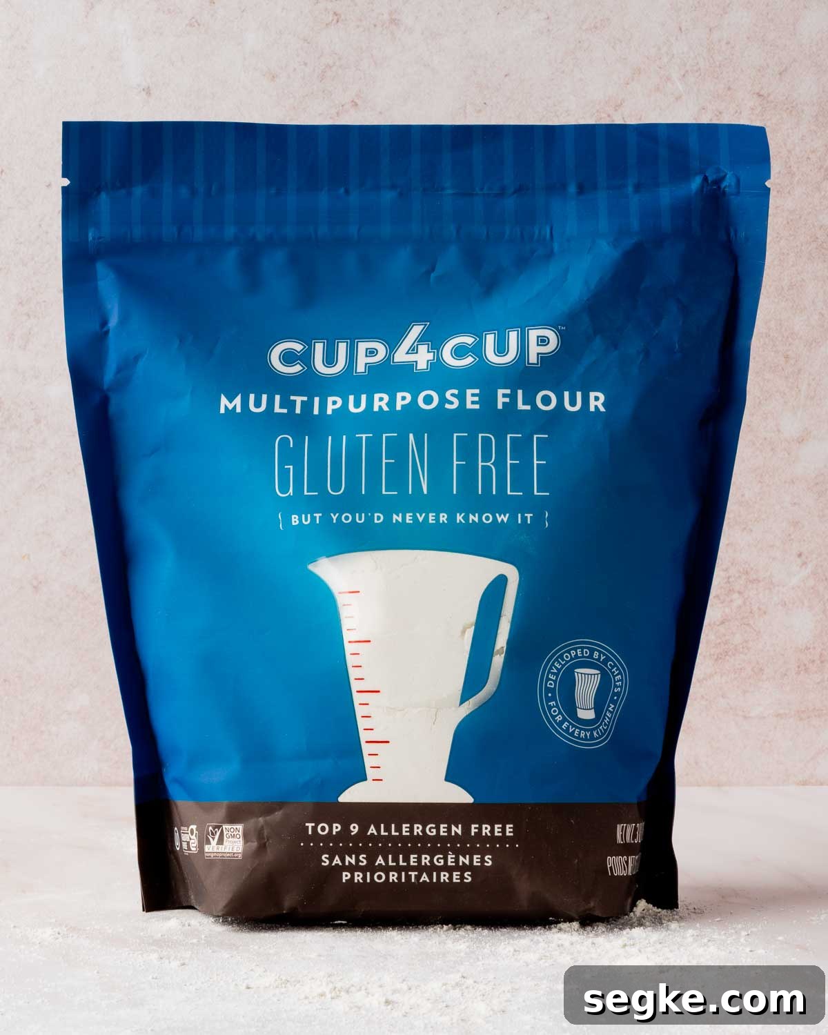 A bag of Cup4Cup resting on pink background.