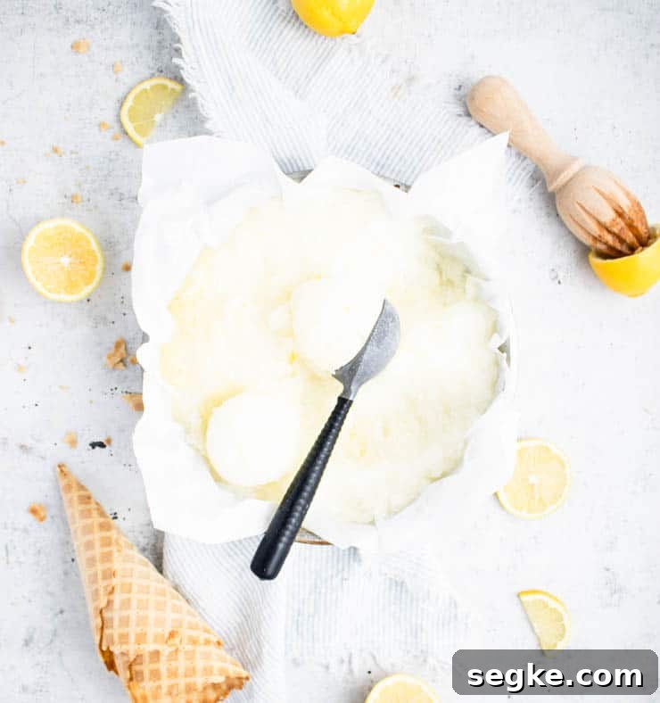 lemon sorbet in a cake pan with ice cream cones and lemons around it.