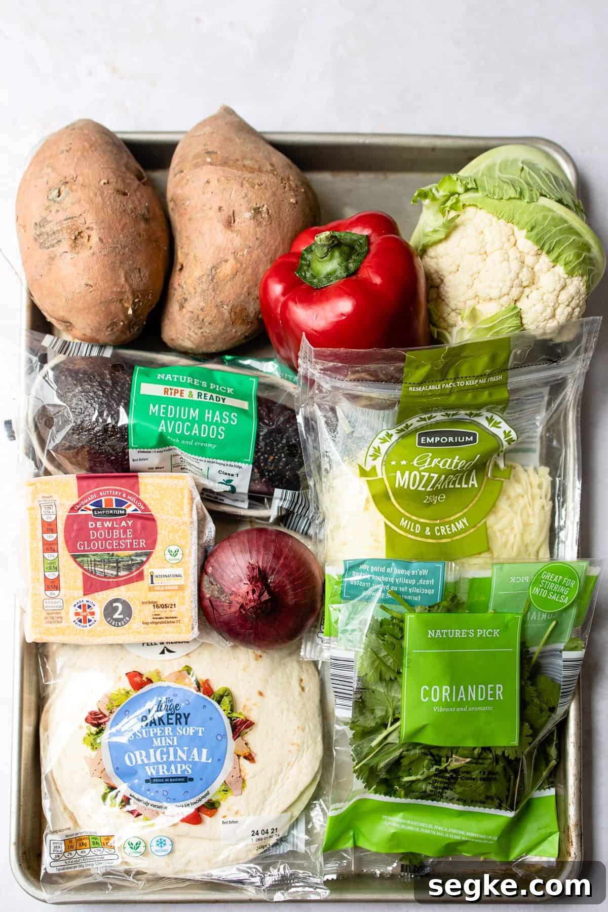 Ingredients for veggie enchiladas laid out on a tray.