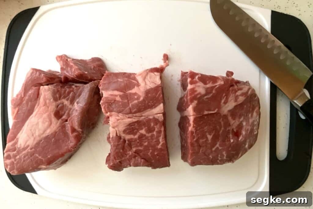 Instant Pot Mississippi Pot Roast Recipe (Juicy & Tender) 4 Preparing Chuck Roast Step 1. Cutting into large separate pieces to make instant pot Mississippi roast.