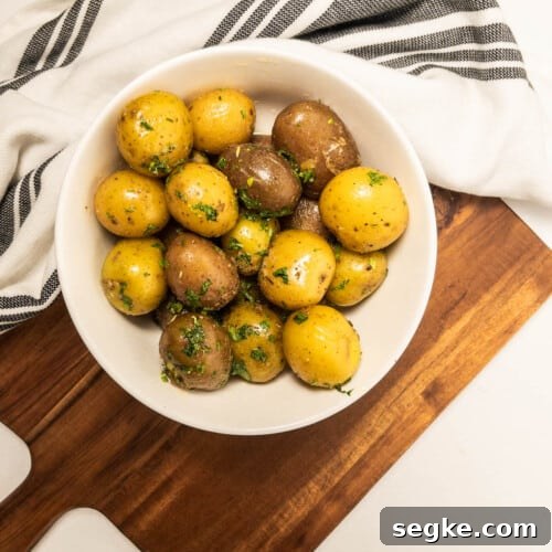 garlic herb potatoes in bowl on serving board
