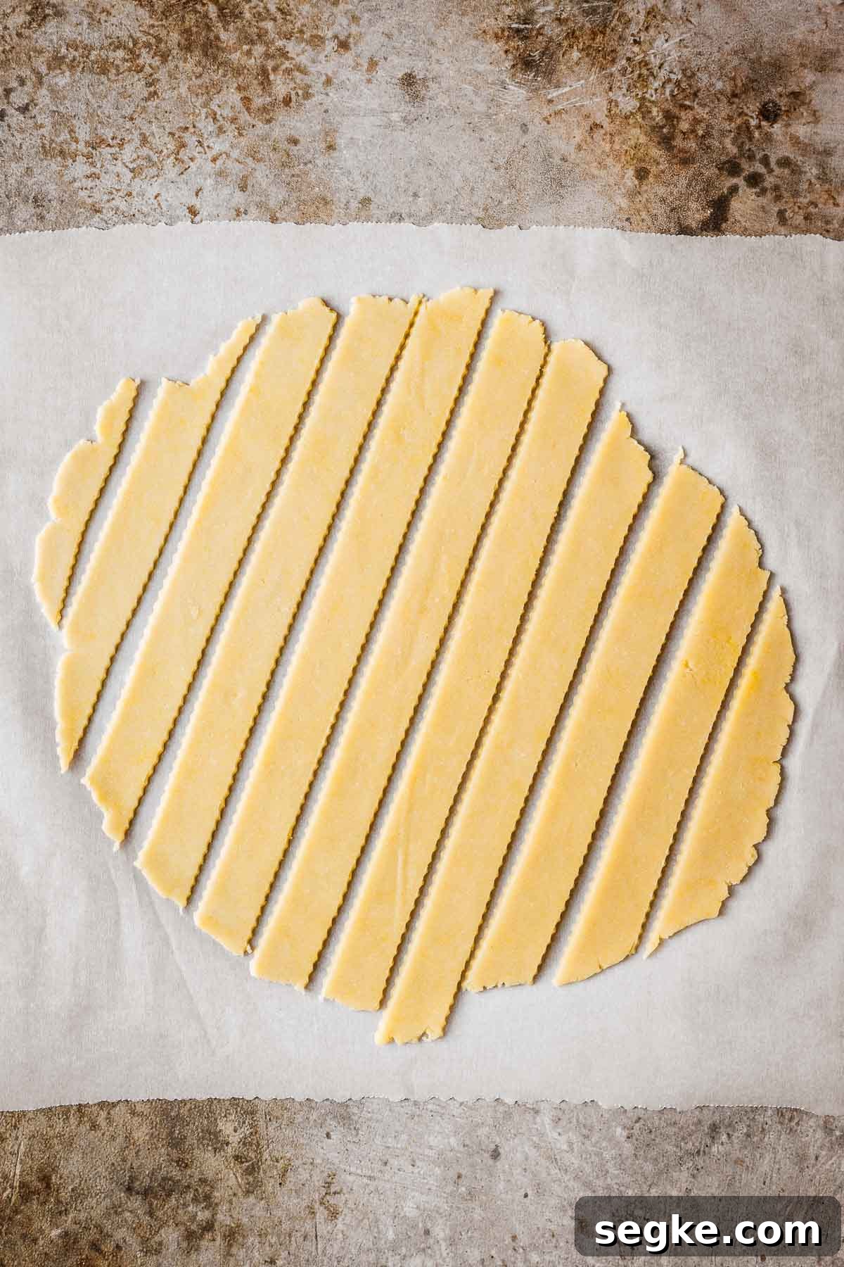 Nutella Crostata: Italian Hazelnut Chocolate Tart Recipe 12 Fluted strips of lattice dough on a sheet of parchment paper