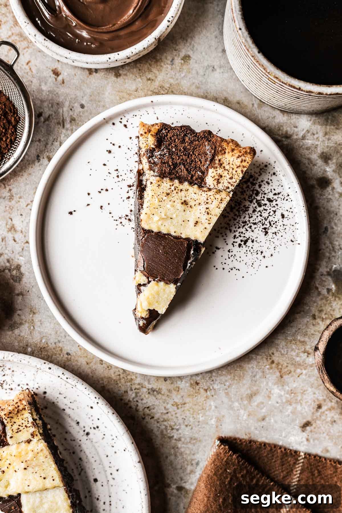 Nutella Crostata: Italian Hazelnut Chocolate Tart Recipe 19 A slice of lattice woven nutella tart on a white plate