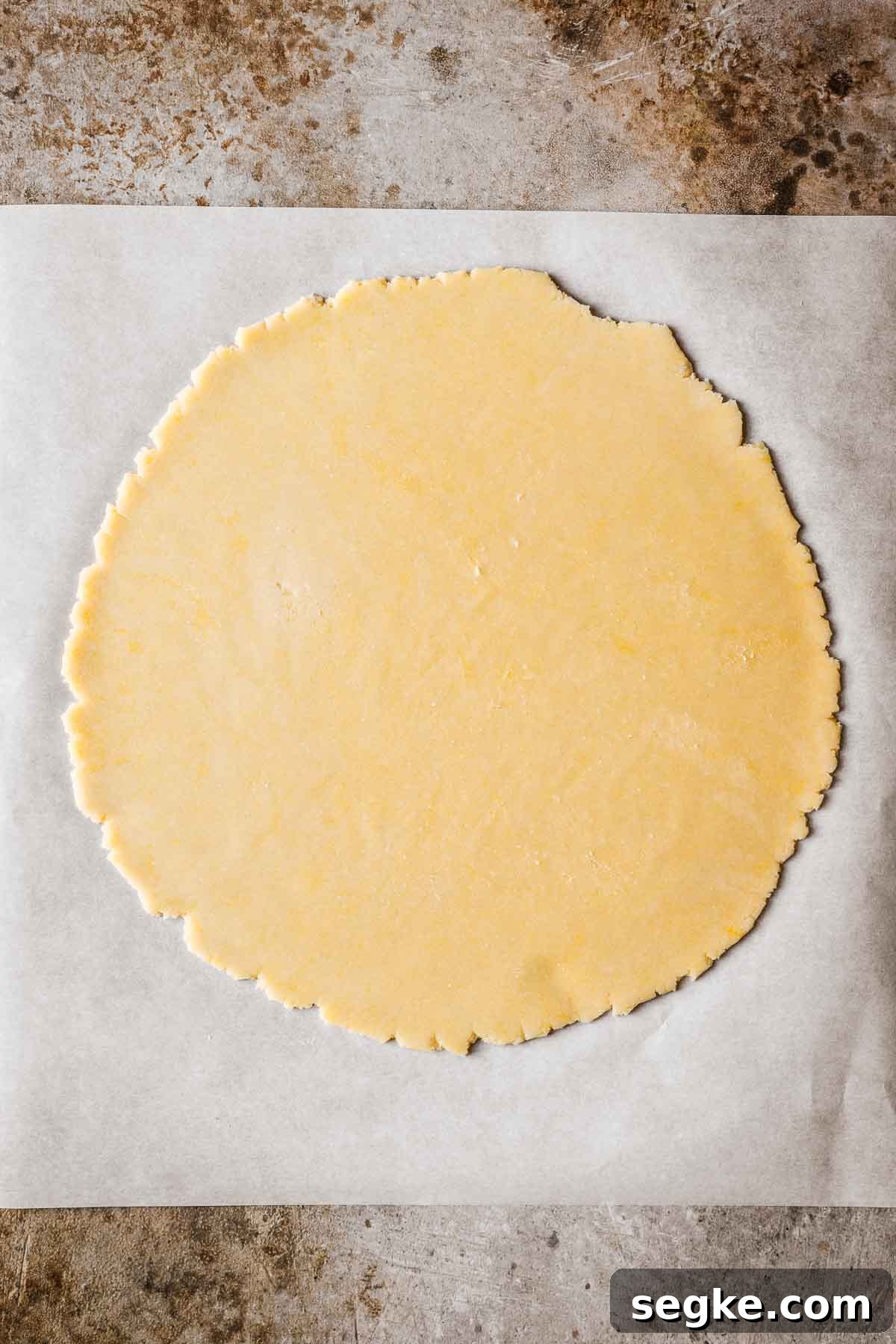 Nutella Crostata: Italian Hazelnut Chocolate Tart Recipe 10 A circle of rolled out dough on parchment paper