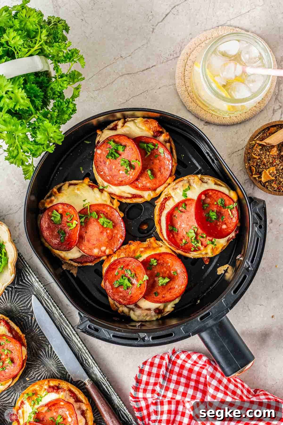 Crispy Air Fryer Pizza Bagels Recipe 8 air fryer basket with 4 pepperoni bagels in it