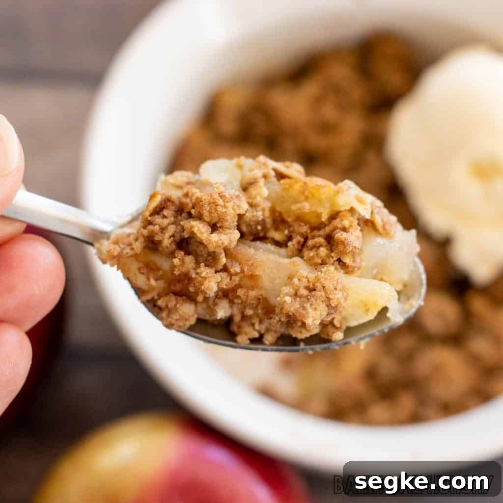 Individual Apple Crumble Recipe for One 2 bite of apple crisp on a spoon