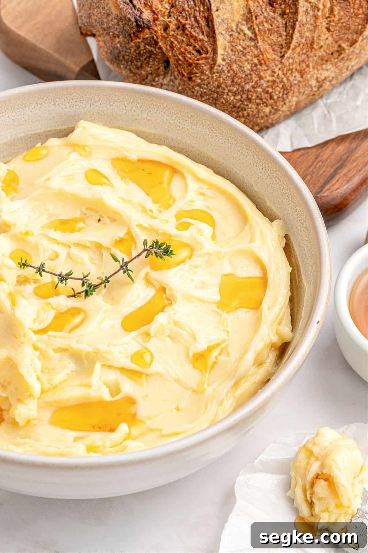 Whipped Honey Butter Recipe in 5 Minutes 2 Off white bowl with honey butter. Bread, white background.