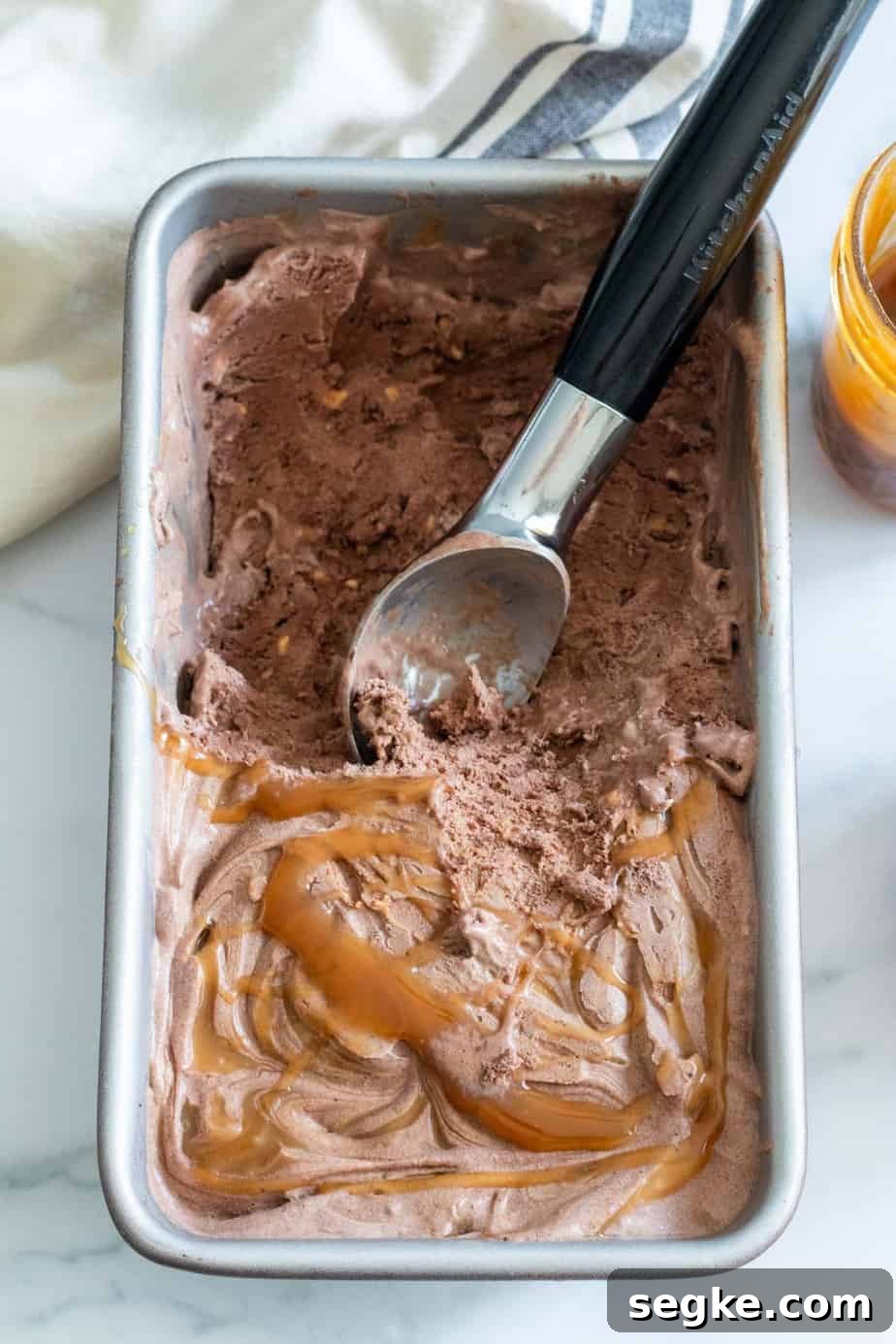 loaf pan of chocolate ice cream with caramel drizzle