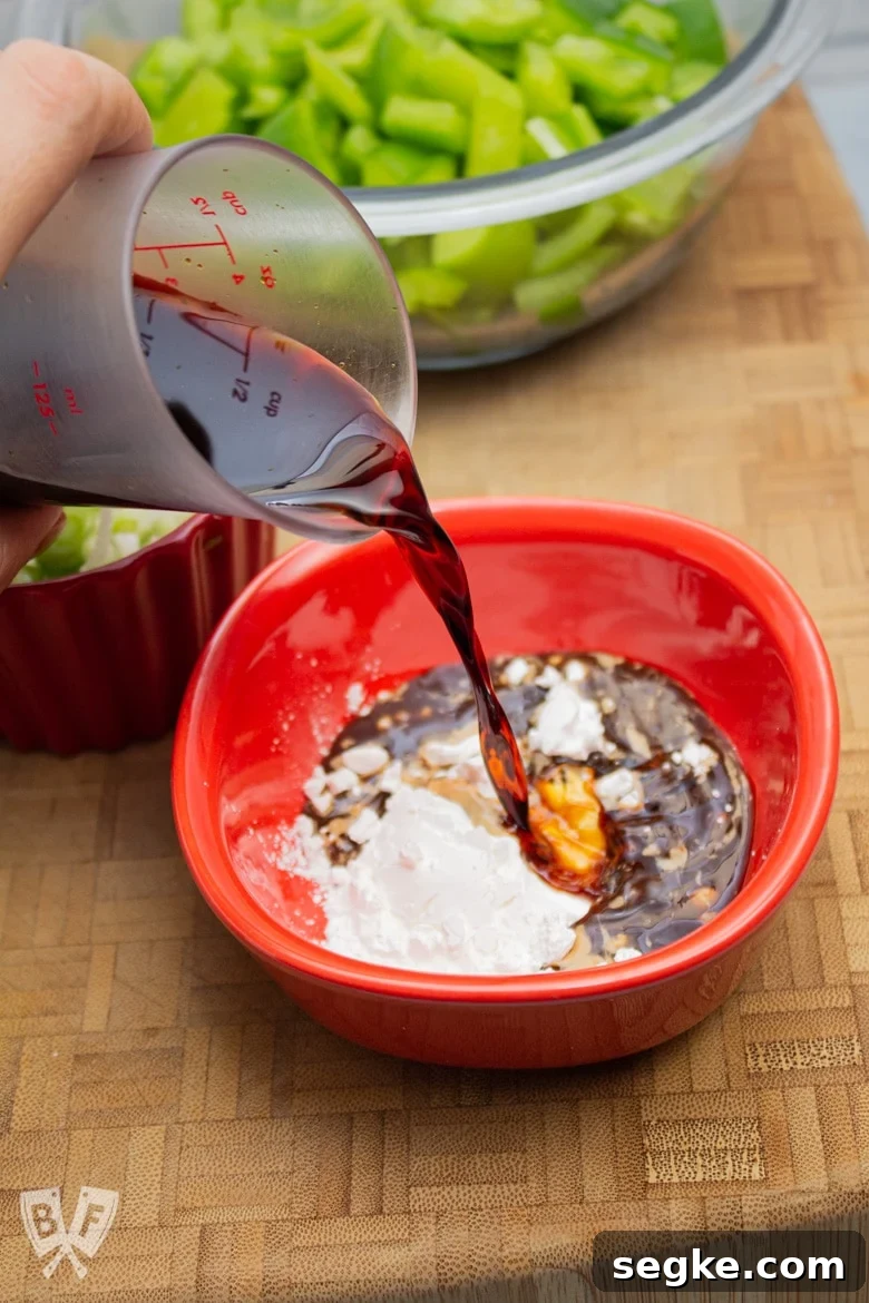 Soy-Ginger Chicken and Bell Pepper Stir-Fry 4 Pouring soy sauce into a small bowl of cornstarch.