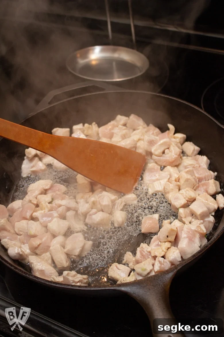 Soy-Ginger Chicken and Bell Pepper Stir-Fry 6 Cooking cubed chicken breast in a cast iron skillet.
