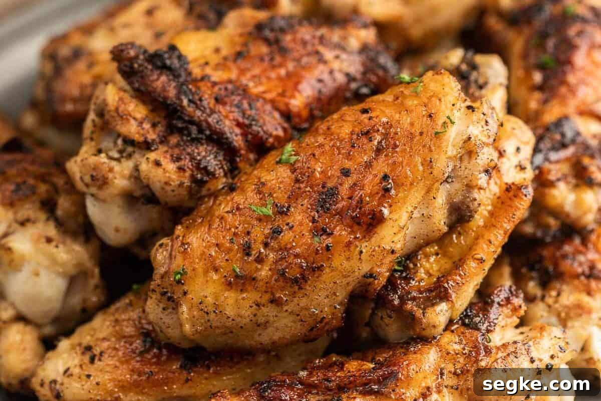 Blackstone Chicken Wings, seasoned with pepper and herbs, stacked together and ready to eat.