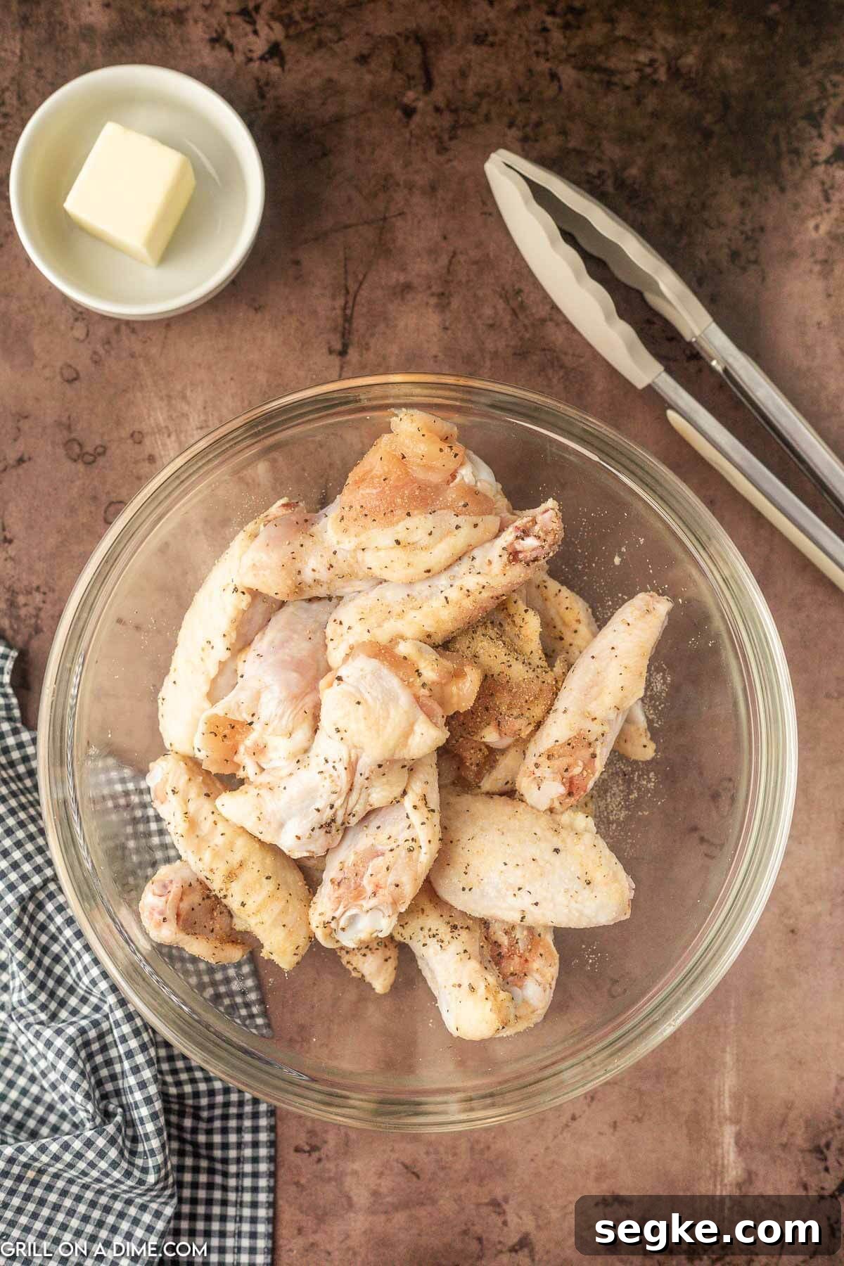 Mixing the chicken wings in a bowl with seasoning