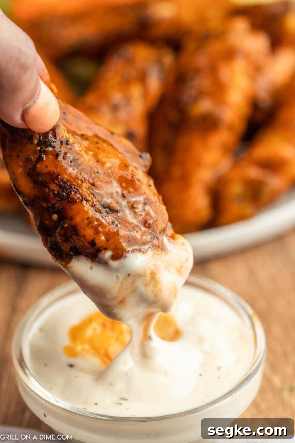 Dipping Buffalo Chicken wings in ranch.