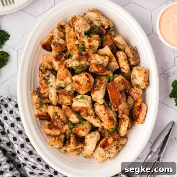 Chicken bites in a white serving dish.